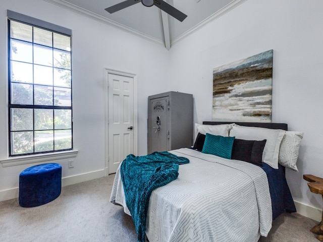 carpeted bedroom featuring multiple windows, ceiling fan, crown molding, and vaulted ceiling