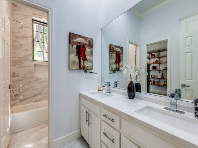 bathroom featuring vanity, tiled shower / bath, and crown molding