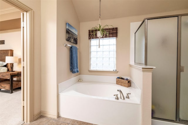 bathroom featuring lofted ceiling, tile patterned floors, and separate shower and tub