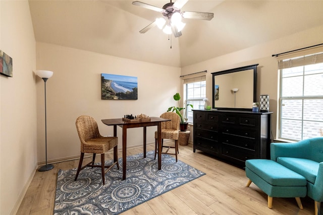 office space featuring lofted ceiling, light wood-style flooring, baseboards, and a ceiling fan