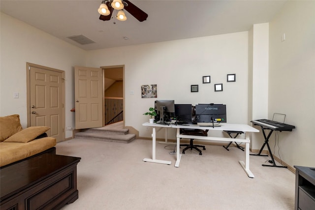 office space featuring ceiling fan, baseboards, visible vents, and light colored carpet