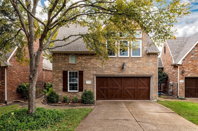 view of front facade featuring driveway, brick siding, an attached garage, and roof with shingles