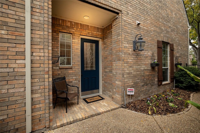 property entrance with brick siding