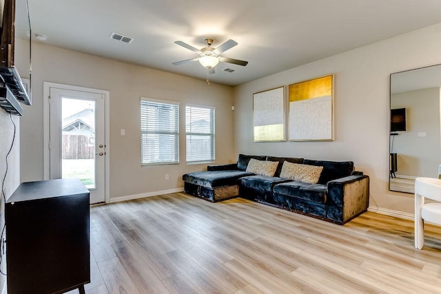 living room featuring ceiling fan and light wood-type flooring