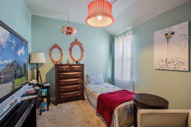 bedroom featuring light carpet and lofted ceiling