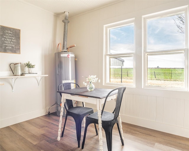 dining room with water heater and wood finished floors