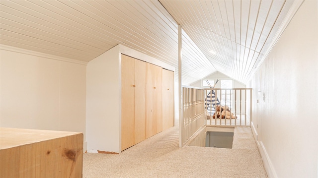 corridor with lofted ceiling and carpet