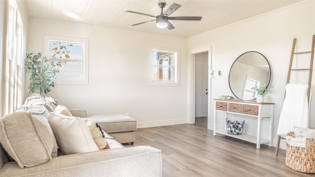 sitting room with ceiling fan, light hardwood / wood-style floors, and ornamental molding