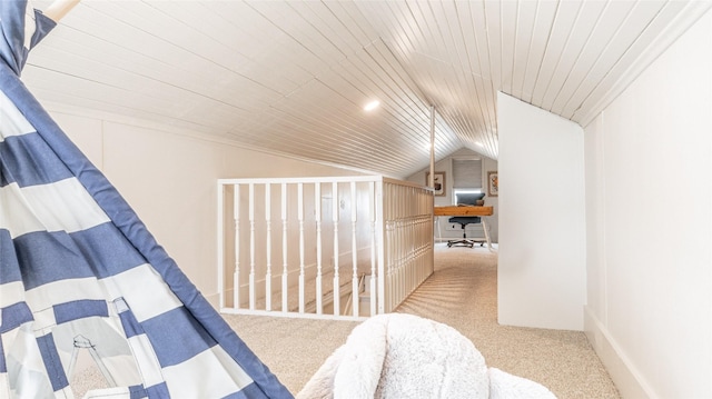 interior space featuring wooden ceiling, carpet, and vaulted ceiling