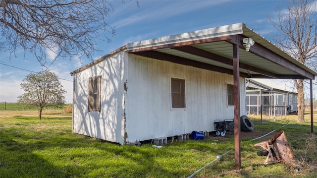 view of side of home with a yard