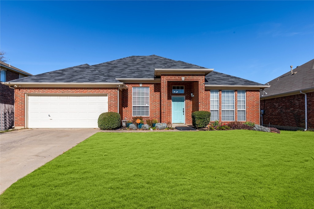 view of front of property featuring a garage and a front yard