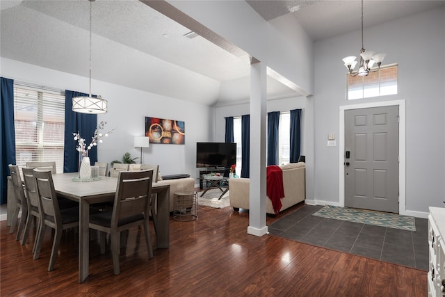 dining room with a notable chandelier, plenty of natural light, dark hardwood / wood-style flooring, and high vaulted ceiling