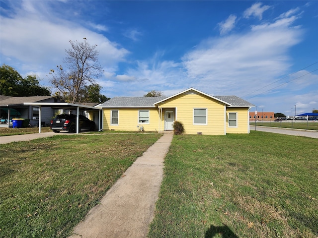 ranch-style home featuring a carport and a front yard