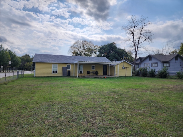 back of house with a yard and a patio