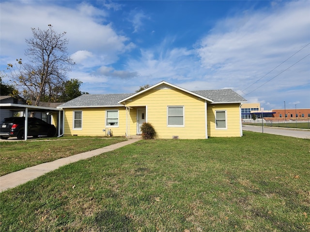 ranch-style home featuring a front yard and a carport