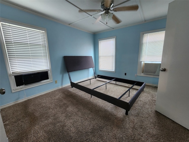 unfurnished bedroom with ceiling fan, crown molding, and carpet floors