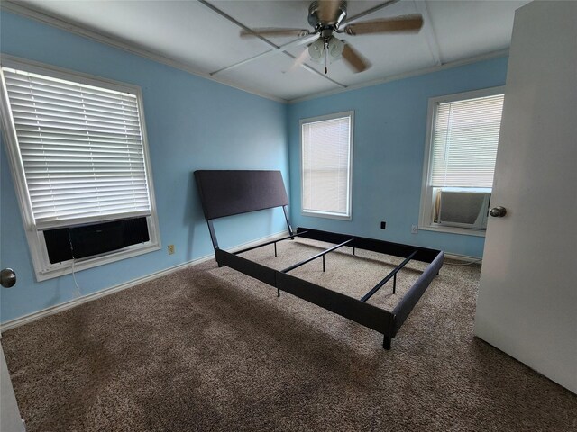 unfurnished bedroom featuring ornamental molding, carpet, and ceiling fan