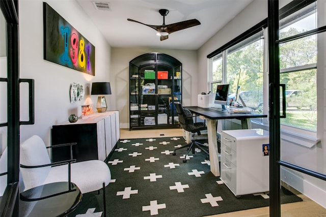 home office featuring dark hardwood / wood-style flooring and ceiling fan