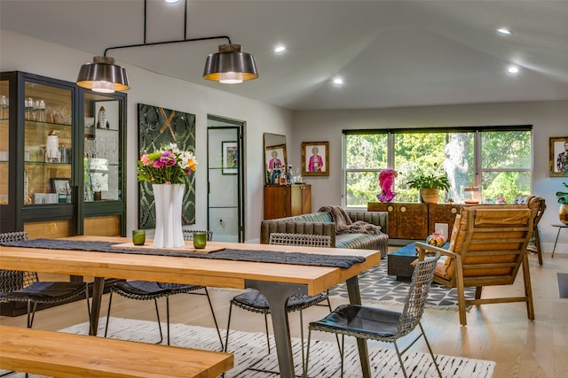 dining room featuring light hardwood / wood-style flooring and lofted ceiling