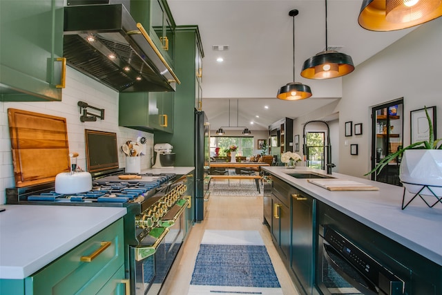 kitchen with decorative light fixtures, extractor fan, range with two ovens, and backsplash