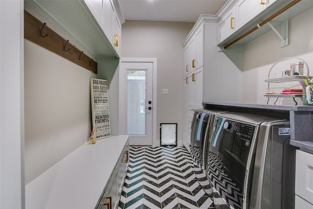 laundry room with washer and dryer and cabinets