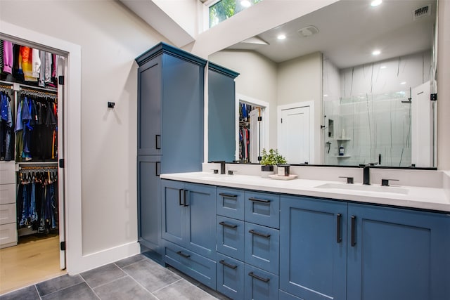 bathroom with vanity, tile patterned floors, and a shower with door