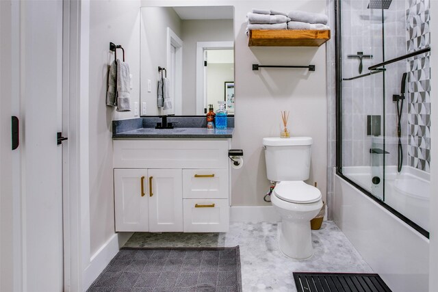 full bathroom featuring vanity, combined bath / shower with glass door, and toilet