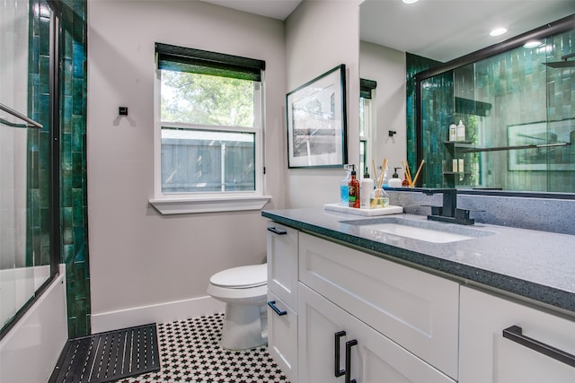 full bathroom featuring shower / bath combination with glass door, tile patterned floors, vanity, and toilet