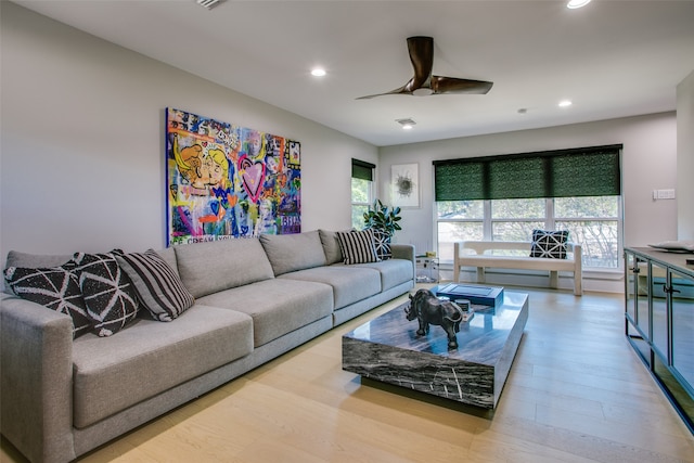 living room with ceiling fan and light hardwood / wood-style floors