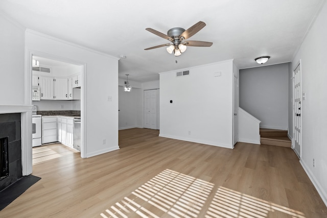 unfurnished living room featuring ornamental molding, ceiling fan, and light hardwood / wood-style flooring