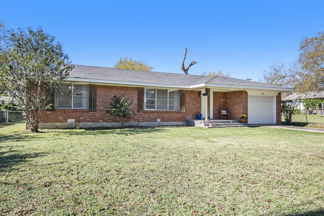 ranch-style house featuring a front yard and a garage