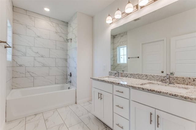 bathroom featuring tiled shower / bath combo and vanity