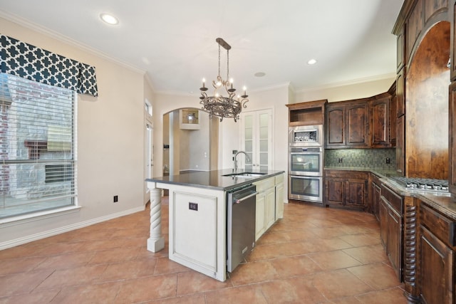 kitchen featuring crown molding, sink, an island with sink, tasteful backsplash, and stainless steel appliances