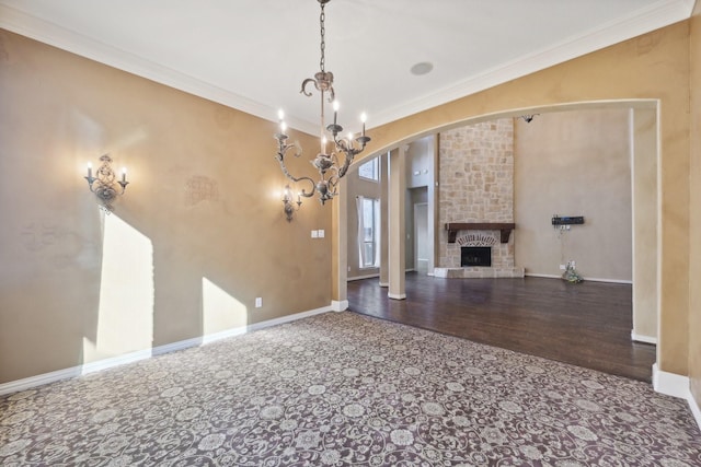 unfurnished living room featuring hardwood / wood-style flooring, ornamental molding, and a fireplace