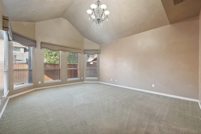 carpeted empty room featuring lofted ceiling and an inviting chandelier