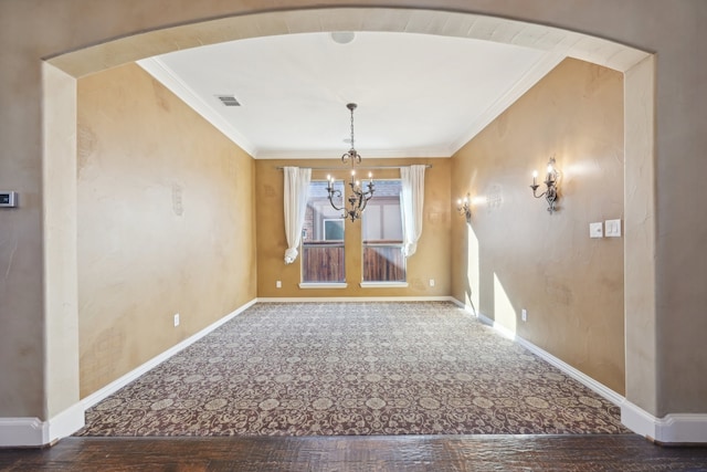 unfurnished dining area with crown molding, hardwood / wood-style floors, and an inviting chandelier