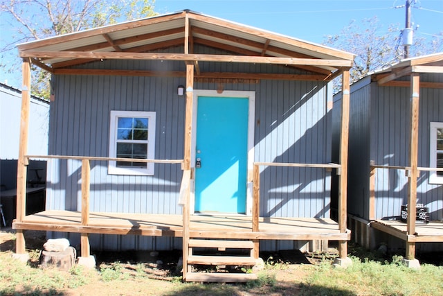 rear view of house with a storage unit