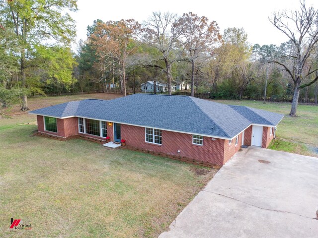 single story home featuring a garage and a front yard