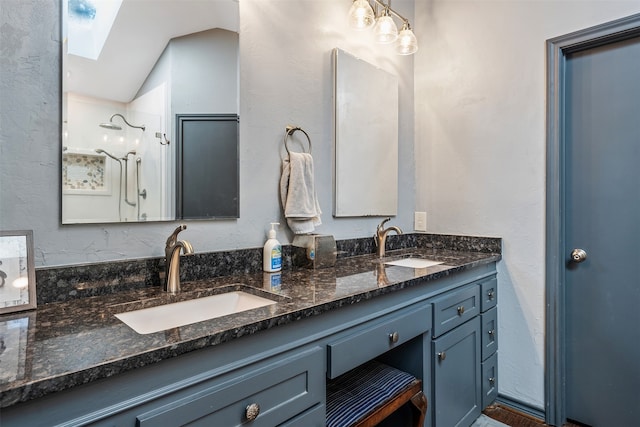 bathroom featuring walk in shower, lofted ceiling, and vanity