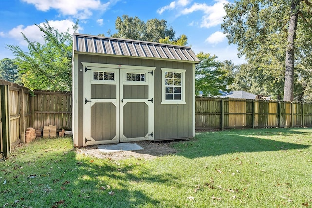 view of outbuilding featuring a yard