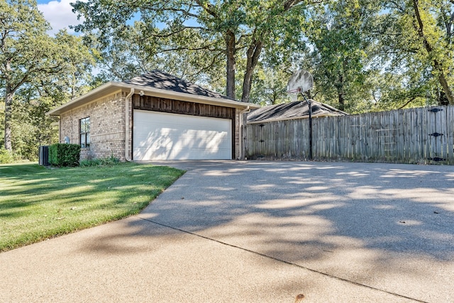 view of side of property featuring an outbuilding, a garage, and a lawn