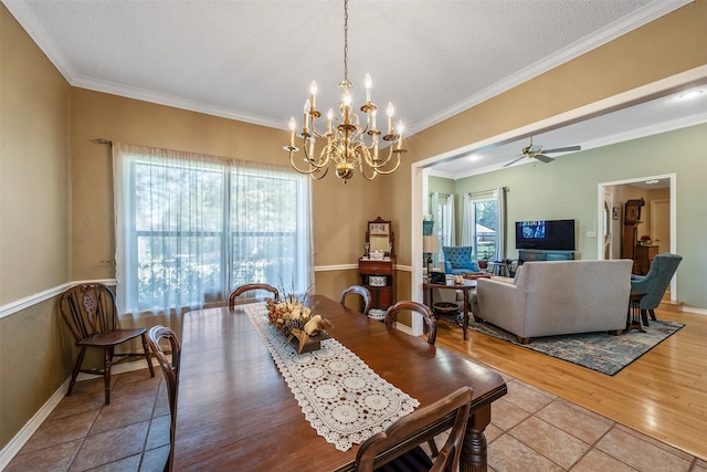 dining area with crown molding, light hardwood / wood-style flooring, a textured ceiling, and ceiling fan