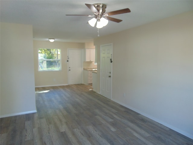 spare room with ceiling fan and dark hardwood / wood-style flooring