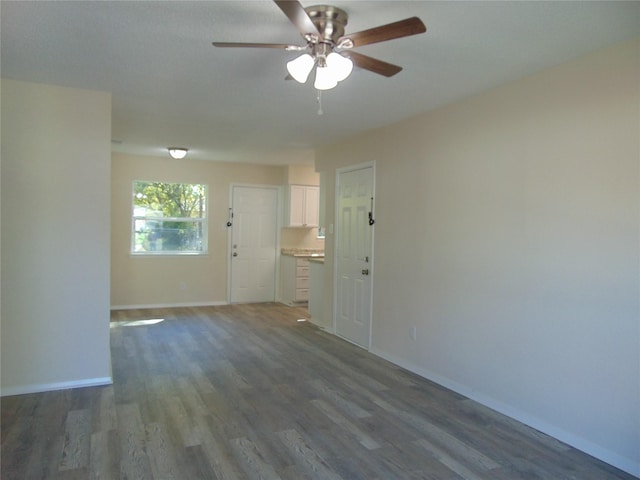 empty room featuring dark hardwood / wood-style floors and ceiling fan