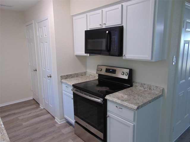 kitchen featuring light hardwood / wood-style floors, white cabinets, and stainless steel electric range oven