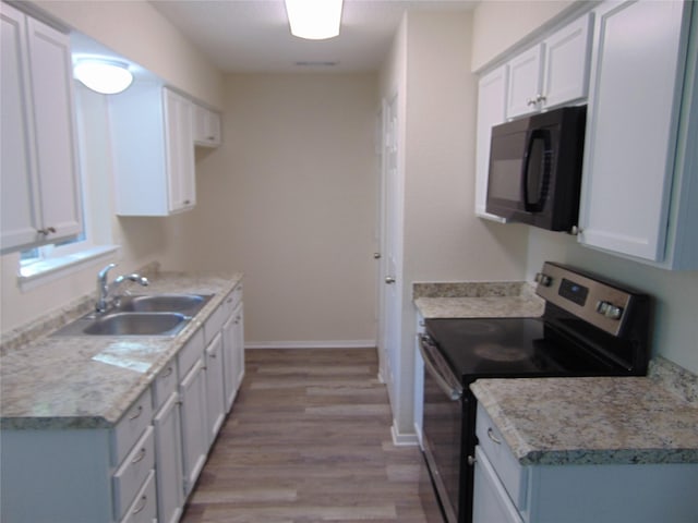 kitchen with white cabinetry, sink, and stainless steel electric range oven