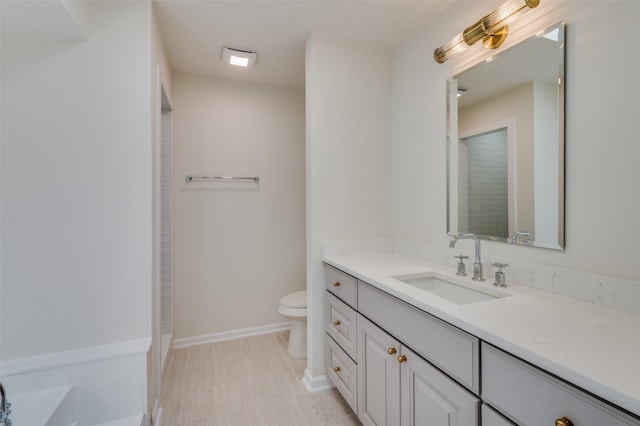 bathroom with tile patterned flooring, vanity, and toilet