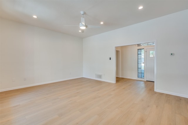 empty room with ceiling fan and light hardwood / wood-style flooring