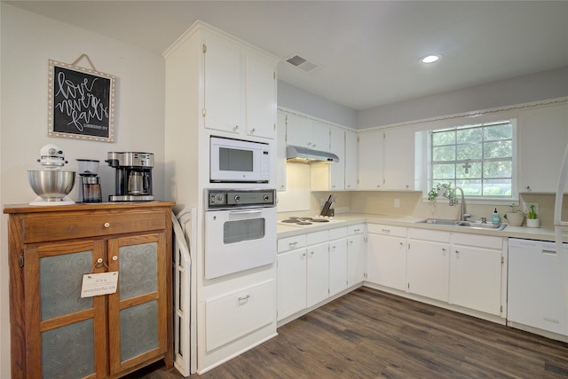 kitchen featuring white cabinetry, sink, dark hardwood / wood-style flooring, and white appliances