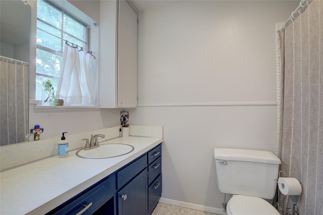 bathroom featuring toilet and vanity